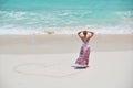 Girl drawing a heart on the beach Royalty Free Stock Photo