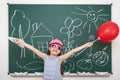 Girl drawing home and garden on school board Royalty Free Stock Photo