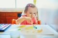 Girl drawing rainbow with colorful aquarelle paints Royalty Free Stock Photo