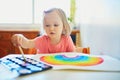 Girl drawing rainbow with colorful aquarelle paints Royalty Free Stock Photo