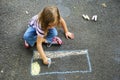 Girl drawing with sidewalk chalk