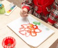 A girl draws a drawing with paints on a sheet Royalty Free Stock Photo