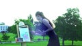 Girl draws on plein air on green grass in city park