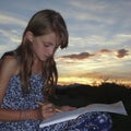 A Girl Draws in a Sketch Pad Royalty Free Stock Photo