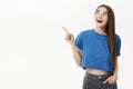 Girl dreaming about flying to warm country on holiday. Portrait of amused happy good-looking european female in blue t