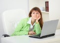 Girl dreams working with laptop at office Royalty Free Stock Photo