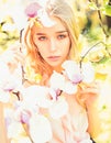 Girl on dreamy face, tender blonde near magnolia flowers, nature background. Young woman enjoy flowers in garden. Spring Royalty Free Stock Photo