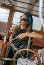 Portrait of a girl at the helm of an old yacht