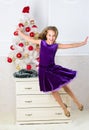 Girl in dress jumping. It is christmas. Day we have waited for all year finally here. Girl excited about christmas jump