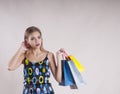 Beautiful girl in a dress with packages fashionable for purchases studio Royalty Free Stock Photo