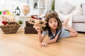 Girl dress up as aviator lying down on floor