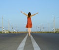 Girl in dress walk barefoot on empty road Royalty Free Stock Photo