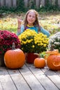 girl dressed as a hippie flower child, flashes a peace sign