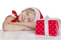 Girl dressed as Santa sleeps Royalty Free Stock Photo