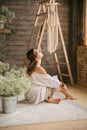 A girl dressed in a bright sit on a white carpet room