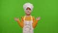 Girl dressed like chef cook pointing at right and left on blank space place for advertisement logo Royalty Free Stock Photo