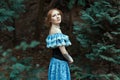 Girl dressed in an old-fashioned blue dress.