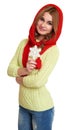 Girl dressed red woolen cap and scarf show big snowflake, posing in studio on white background Royalty Free Stock Photo