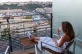 Girl dressed in towel sitting on balcony on Royalty Free Stock Photo