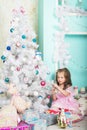 Girl dresses up Christmas tree Royalty Free Stock Photo