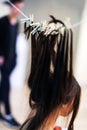 Girl dries hair on a clothesline with clothespins. An unusual way to care for your hair. Vertical photo. Soft focus Royalty Free Stock Photo