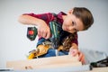 Girl drilling plank