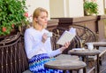 Girl drink coffee while read bestseller book by popular author. Reading is her hobby. Mug coffee and interesting book