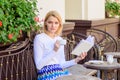 Girl drink coffee while read bestseller book by popular author. Woman have drink cafe terrace outdoors. Reading is her