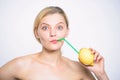 Girl drink fresh juice whole lemon fruit with cocktail straw. Benefits of drinking lemon water in morning empty stomach