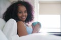 Girl Drinking Coffee In Bed Smiling At Camera Royalty Free Stock Photo