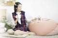 The girl is drinking coffee with a Maltese dog. Young woman and Maltese puppy dog sitting In the living room Royalty Free Stock Photo