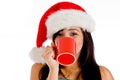 Girl drinking coffee wearing christmas hat Royalty Free Stock Photo