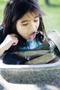 Girl drinking from fountain Royalty Free Stock Photo