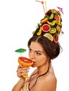 Girl drinking fruit cocktail on summer party. Woman fruits hairstyle. Royalty Free Stock Photo