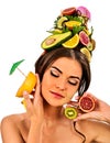 Girl drinking fruit cocktail on summer party. Woman fruits hairstyle. Royalty Free Stock Photo