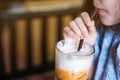 A girl drinking a glass of milk tea in cafe