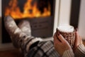 Cozy Winter Nights: Warming by the Fireplace with Hot Tea Royalty Free Stock Photo