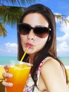 Girl drinking an orange frozen drink Royalty Free Stock Photo