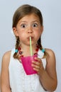 Girl drinking through a straw Royalty Free Stock Photo