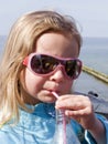 Girl drinking with a straw Royalty Free Stock Photo