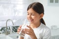 Girl drinking tap water from glass in kitchen Royalty Free Stock Photo