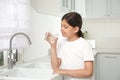 Girl drinking tap water from glass in kitchen Royalty Free Stock Photo