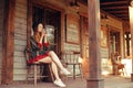 Girl drinking tea / coffee in the Wild West, in Western house. Girl in hat with long cerly hair. Beautiful pretty girl smile. Incr Royalty Free Stock Photo