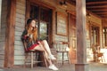 Girl drinking tea / coffee in the Wild West, in Western house. Girl in hat with long cerly hair. Beautiful pretty girl smile. Incr Royalty Free Stock Photo