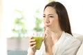 Girl drinking vegetable juice sipping a straw Royalty Free Stock Photo