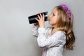 girl drinking water from black cup in white dress and purple wreath Royalty Free Stock Photo