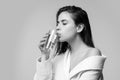 Girl drinking water glass. Beautiful young woman with clean fresh skin. Royalty Free Stock Photo