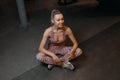 Girl drinking water in gym after workout. Profile of beautiful woman going to drink some water from plastic bottle after Royalty Free Stock Photo