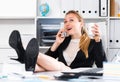 Girl drinking water and lying legs on table Royalty Free Stock Photo