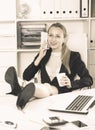 Girl drinking water and lying legs on table Royalty Free Stock Photo